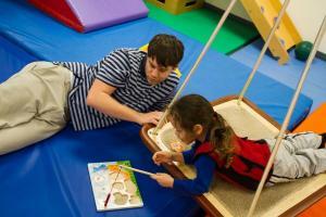 A child playing with a puzzle at Cheshire Fitness Zone.