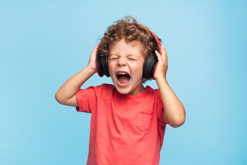 boy wearing headphones listening to loud music