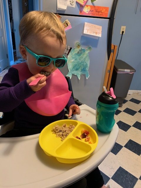 Toddler feeding herself with short spoon