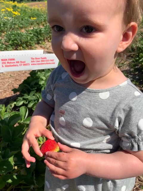 toddler excited about eating a strawberry