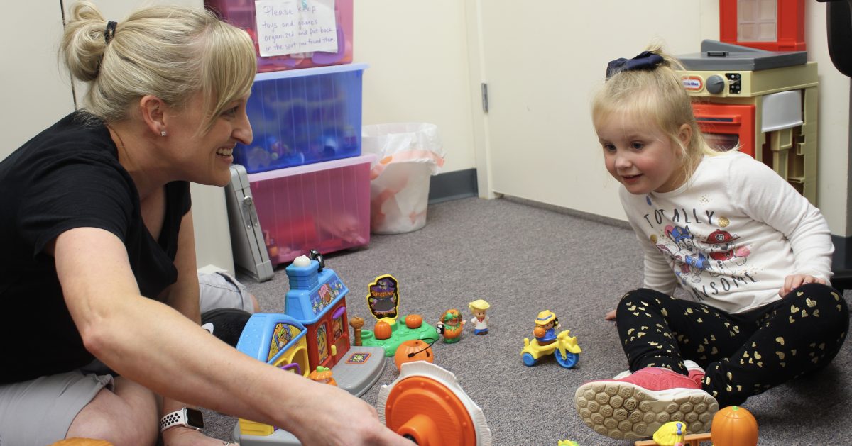 Speech therapist engaging in play based therapy