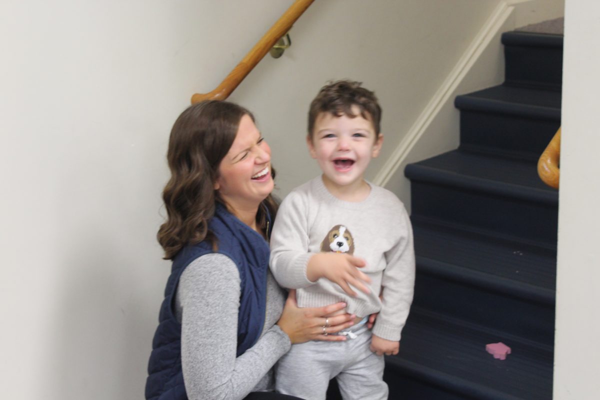 woman laughing with child on stairs