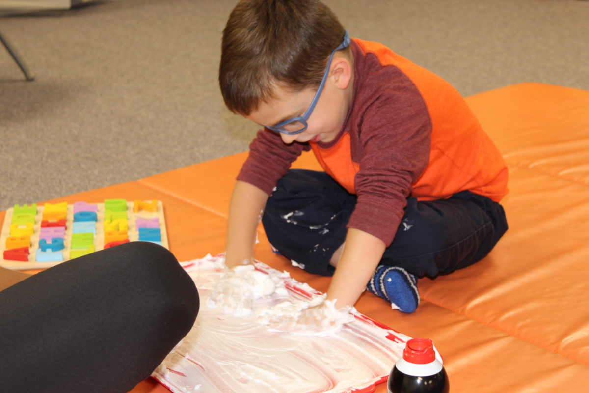 child playing with a tactile item