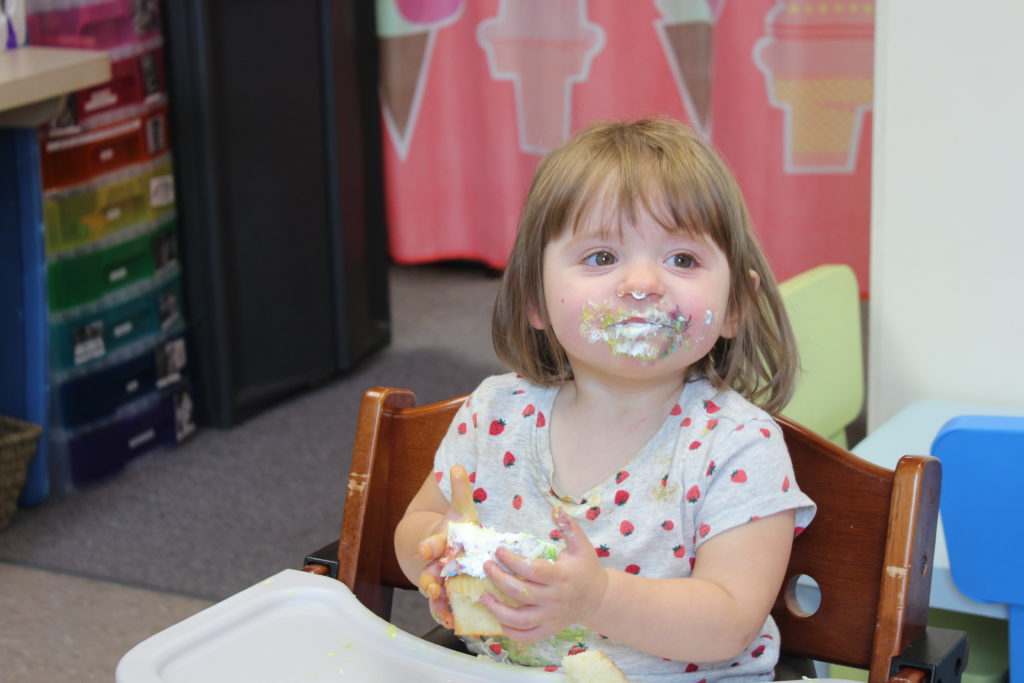 child letting textures touch her face