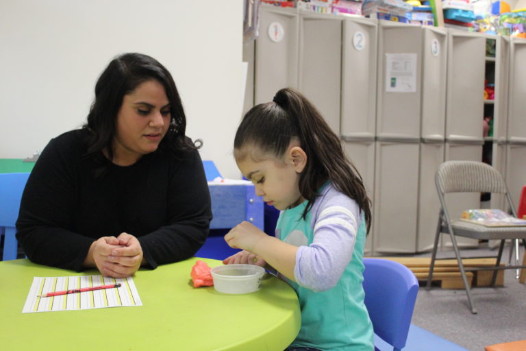 child playing with playdoh