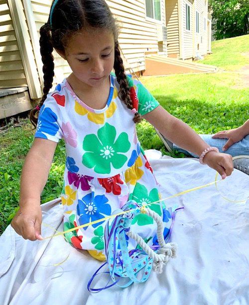 Child creating a hand kite sensory activity.