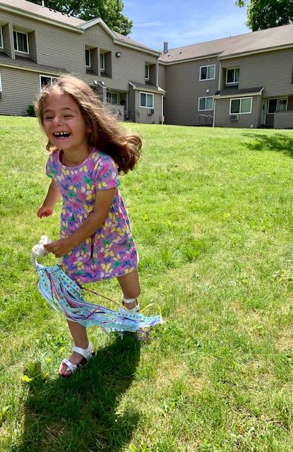 Child running with hand kite