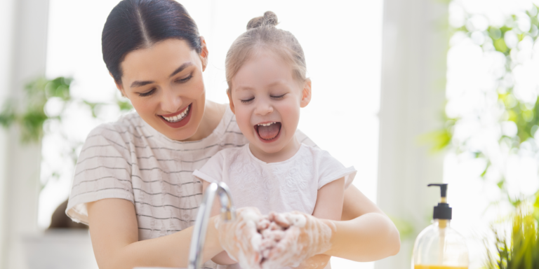 Child and Parent Smiling Washing Hands