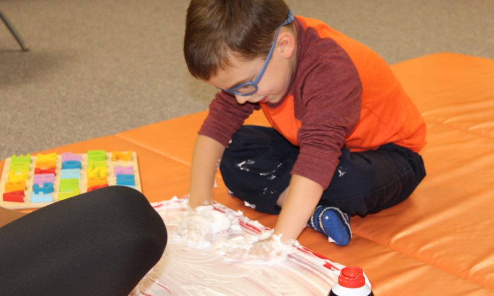 child playing with a tactile item