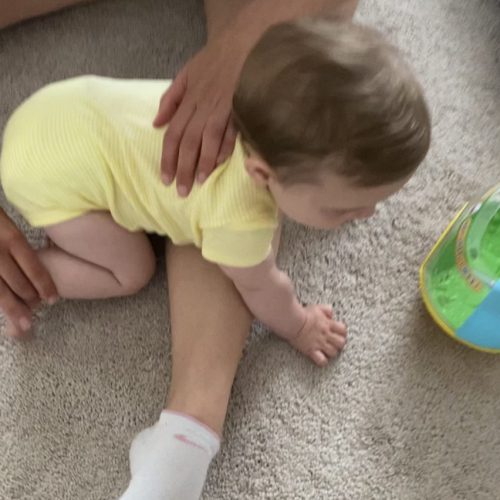 Baby crawling over leg