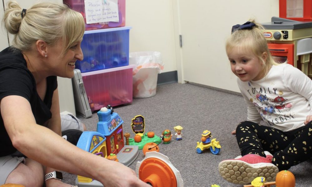 Speech therapist engaging in play based therapy