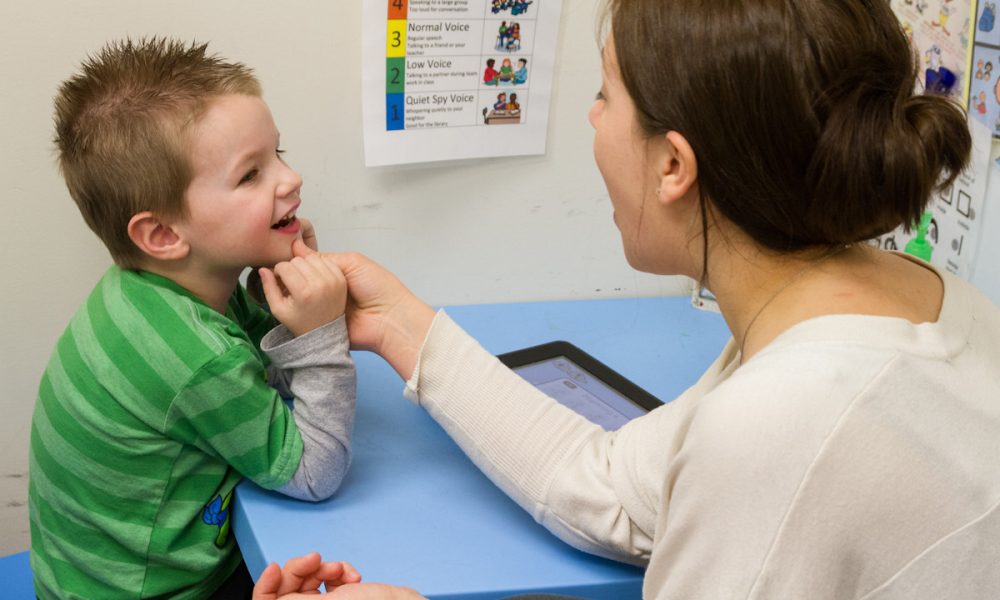 A child during a session with a speech and language pathologist.