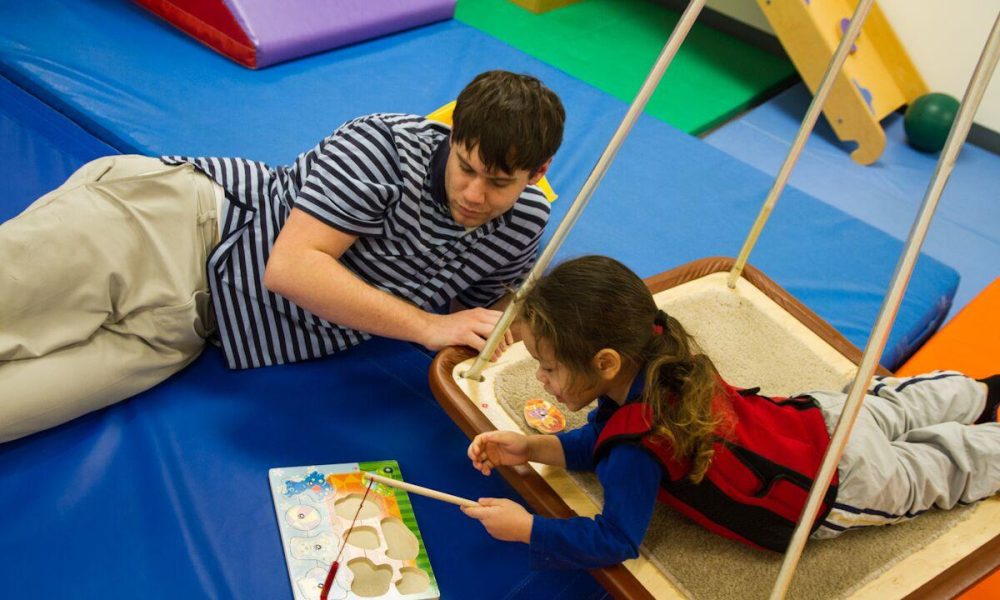 A child playing with a puzzle at Cheshire Fitness Zone.