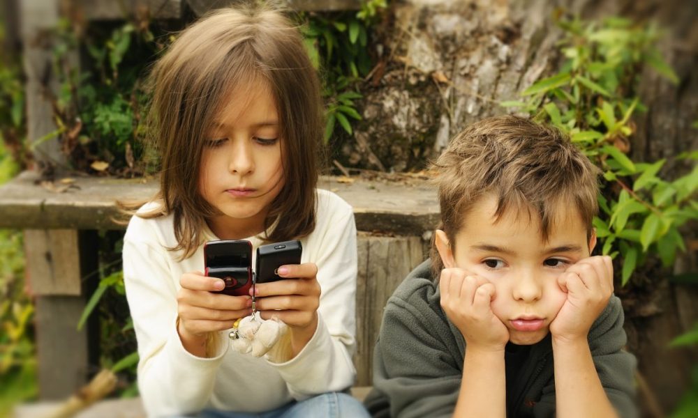 kids  playing in a  mobile phone