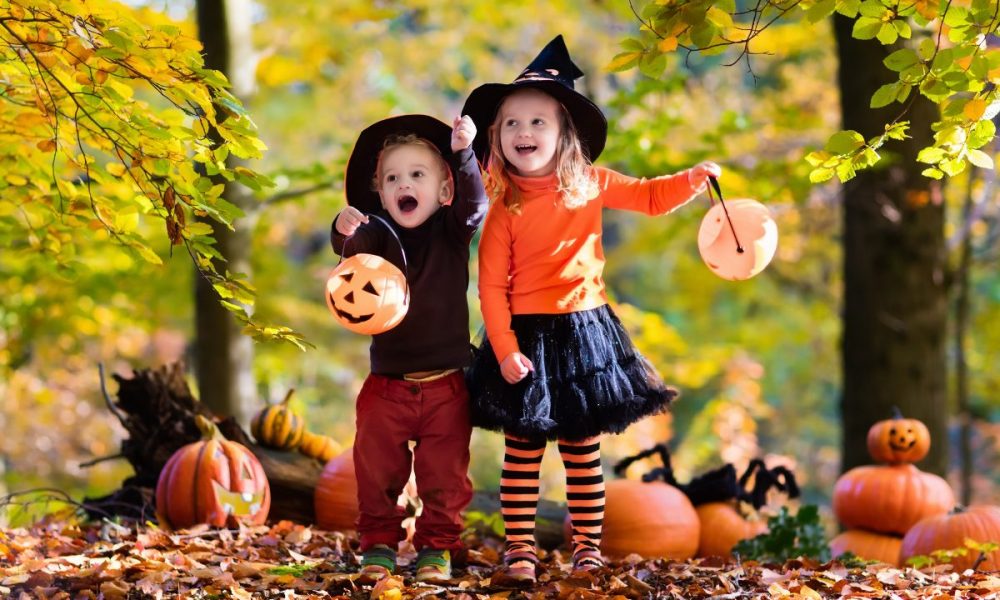 Children having fun partaking in Halloween activities. They are wearing costumes and going trick-or-treating.